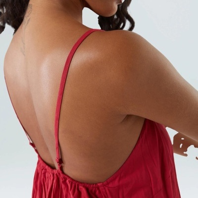 Vestido vermelho de tecido leve com alças finas ajustáveis visto pelas costas