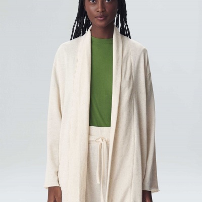 Casaco aberto de malha bege claro com t-shirt verde e calças combinando