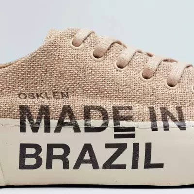 Ténis bege com sola branca com texto 'MADE IN BRAZIL'