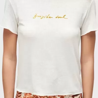 T-shirt branca com texto amarelo e calças florais