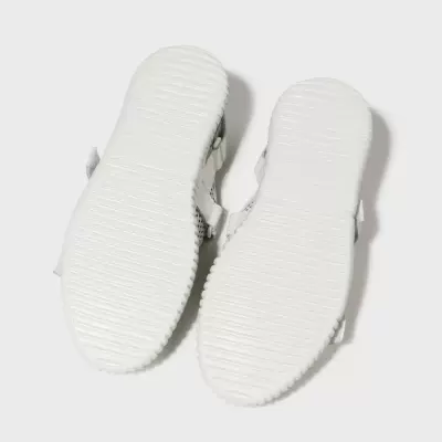 Sandálias brancas mostradas debaixo para cima com sola texturizada