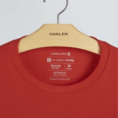 T-shirt vermelha OSKLEN com etiqueta interna e cabide de madeira da marca OSKLEN