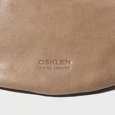 Bolsa de couro bege com logo OSKLEN em relevo