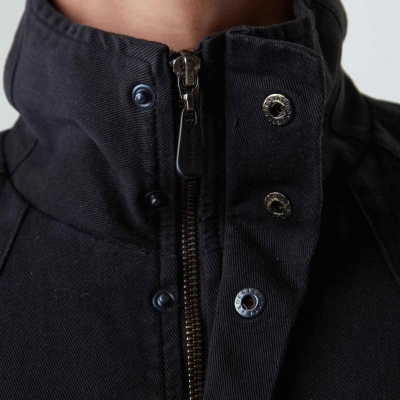 Casaco preto com fecho e botões perto do pescoço