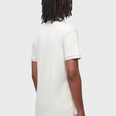 Homem de costas com polo branca e calças bege claras