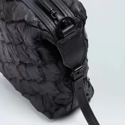 Bolsa de mão preta com textura trançada e fecho de correr preto