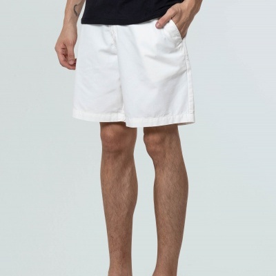 Calções brancos de tecido liso usados por homem com t-shirt preta e ténis pretos