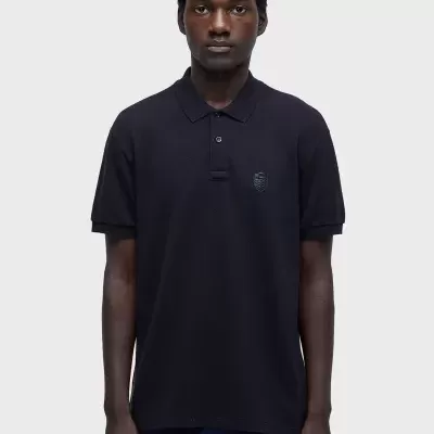 Polo masculino preto com bordado de escudo no peito e gola com botões