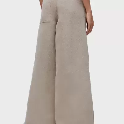 Calças largas bege com bolsos e bainha desfiada vistas de trás