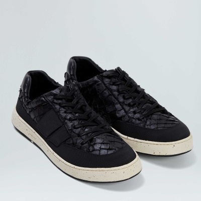 Par de sapatilhas pretas com textura tipo escamas e sola creme