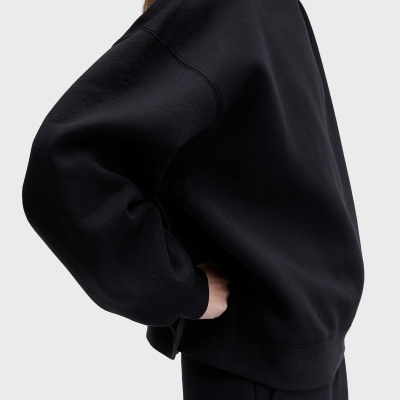Sweatshirt preta de tecido liso com gola, punhos e bainha canelados vista de lado