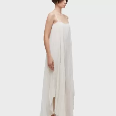 Vestido longo branco plissado com alças finas e sapatos rasos bege