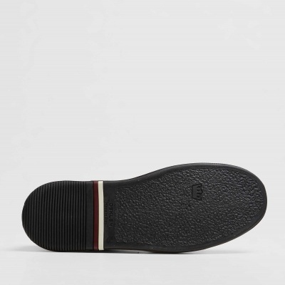 Sola de sapato preta com linhas decorativas vermelha e branca no calcanhar