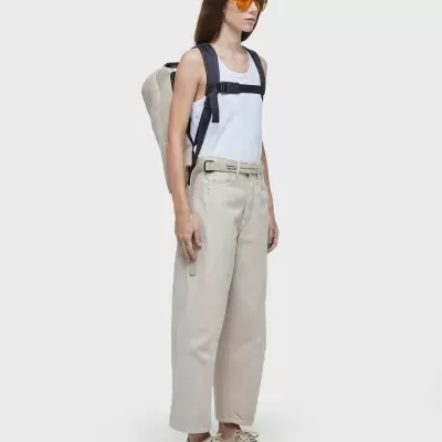 Mulher com roupa casual e mochila em fundo branco