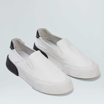 Sapatilhas slip-on brancas com detalhe preto no calcanhar e sola grossa