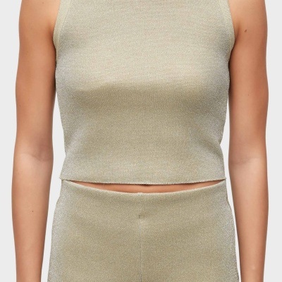 Parte superior de conjunto feminino brilhante cor bege dourado com camisola sem mangas e calças.