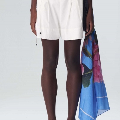 Calções brancos com pregas, sandálias brancas e lenço azul com flores