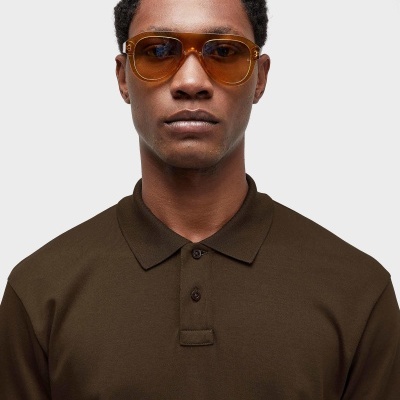 Homem com óculos de sol castanhos e camisa polo castanha