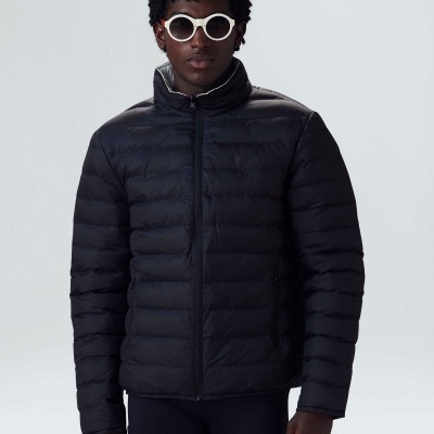 Casaco acolchoado preto com fecho de correr, usado por modelo com óculos de sol brancos