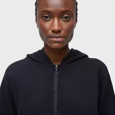 Sweatshirt preta com capuz e fecho de correr numa modelo com fundo branco