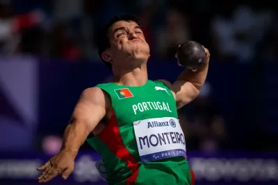 Atleta em uniforme verde e vermelho com placa Allianz Montero 23 Paris 2023 a lançar peso