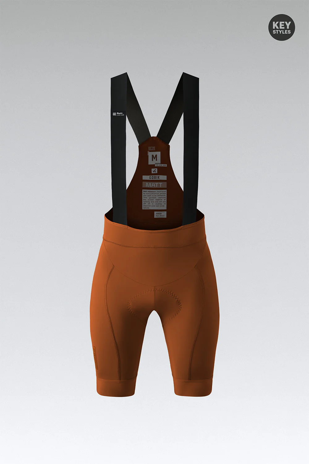 Calções de ciclismo castanhos com tiras pretas suspensas e etiquetas de texto