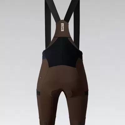 Macacão curto castanho e preto com alças pretas e etiqueta PRET