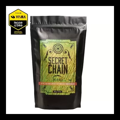 Pacote preto fosco com rótulo verde e amarelo e texto 'SECRET CHAIN BLEND'