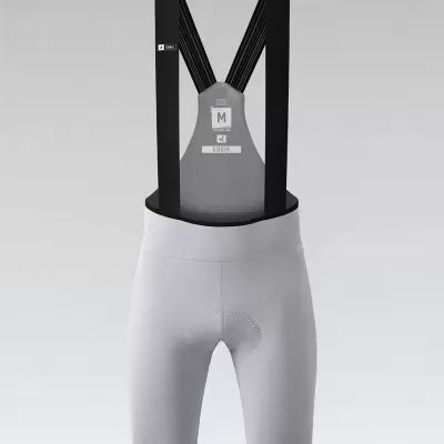 Calções ciclismo cinza claro com alças pretas e etiquetas visíveis