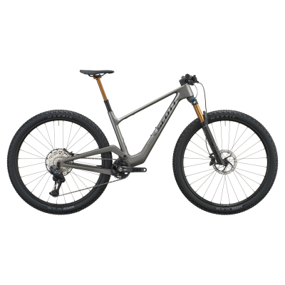 Bicicleta de montanha cinza metálico com suspensão dourada e pneus pretos