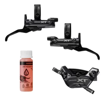 Componentes de bicicleta Shimano Deore XT pretos com frasco de líquido para manutenção