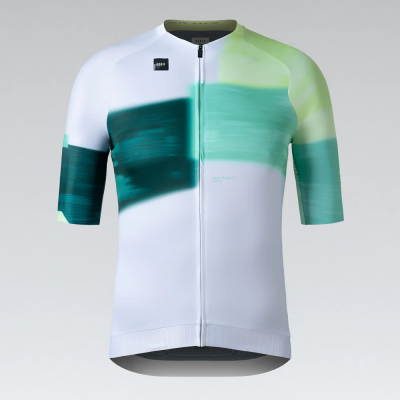 Camisola de ciclismo branca com padrão verde e azul e fecho frontal.