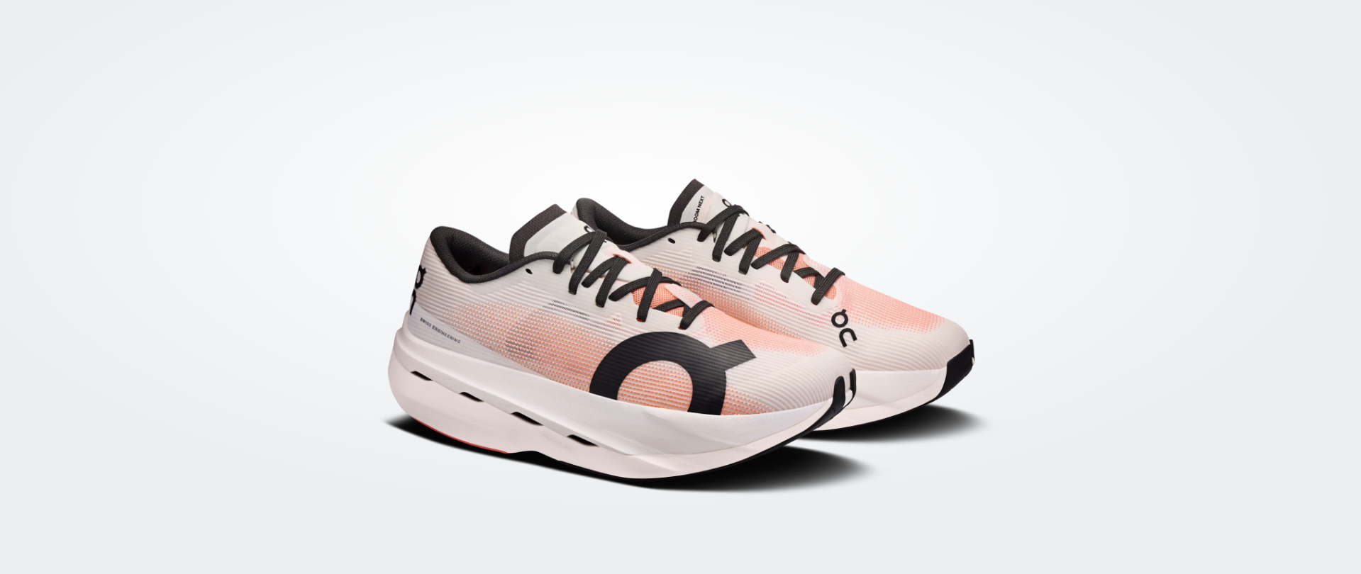 Par de sapatilhas desportivas cor-de-rosa claro e branco com detalhes a preto