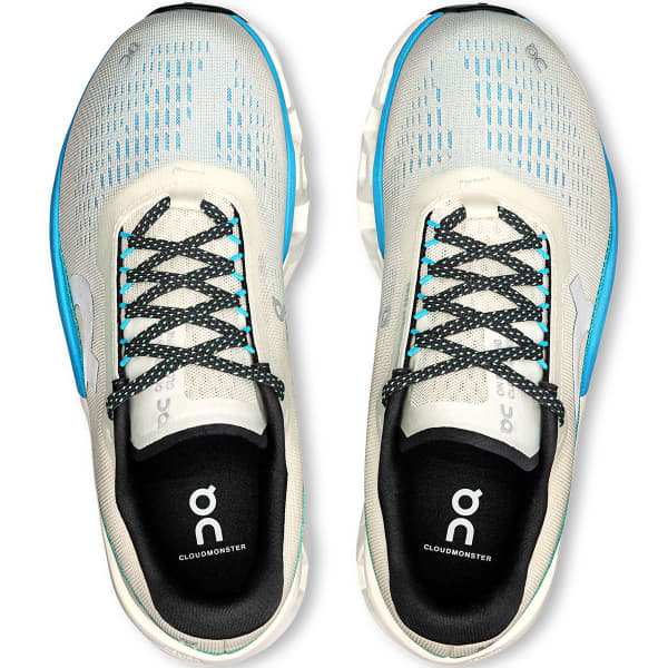 Ténis de corrida On Cloudmonster brancos com detalhes azuis e pretos vistos de cima