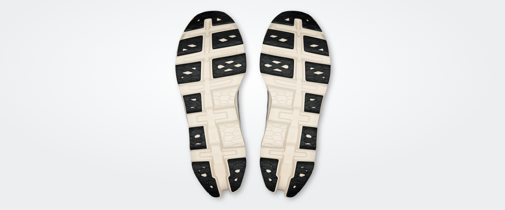 Solados de ténis branco e preto com padrão texturizado e texto CLOUDTEC