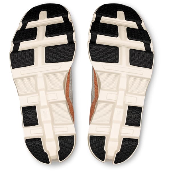 Sola de sapatilhas com desenho preto e branco e laterais castanho e cinzento