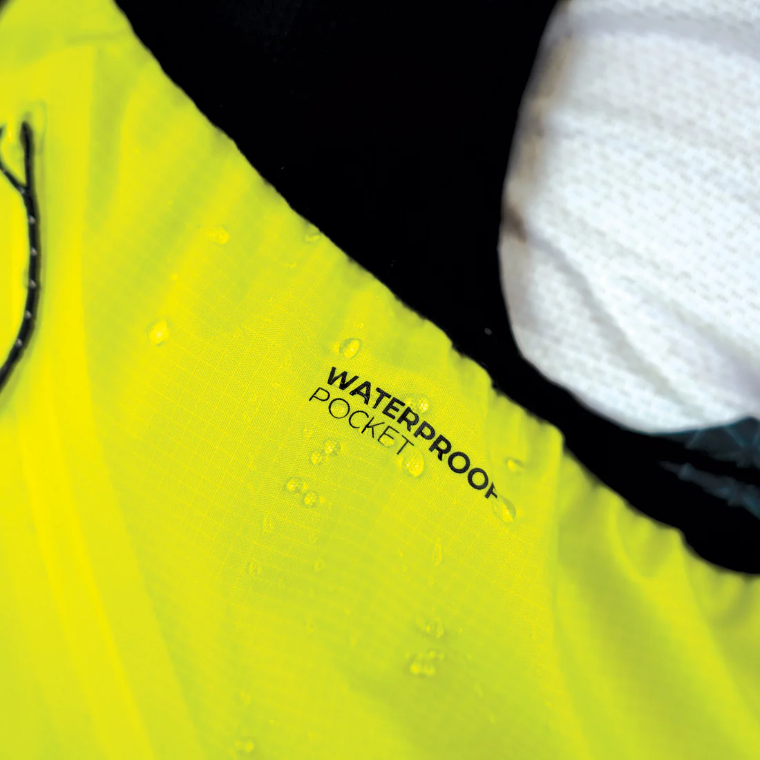 Tecido amarelo com etiqueta WATERPROOF POCKET e gotas de água