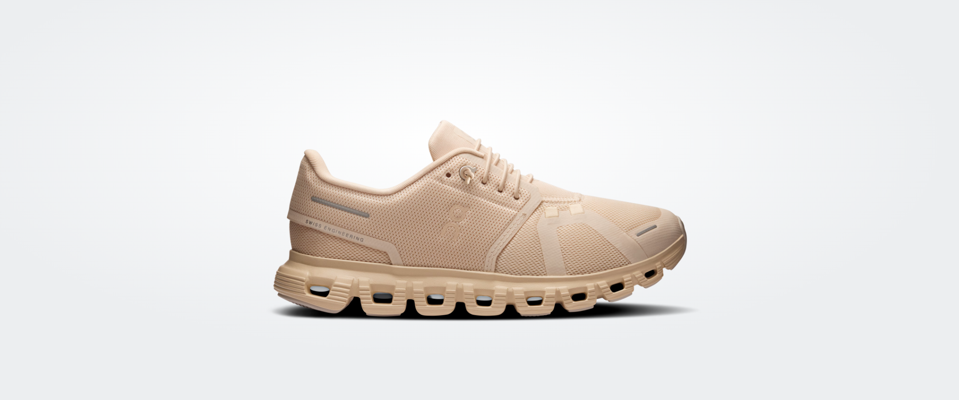 Ténis desportivos bege com sola amortecedora em blocos e cabedal em malha