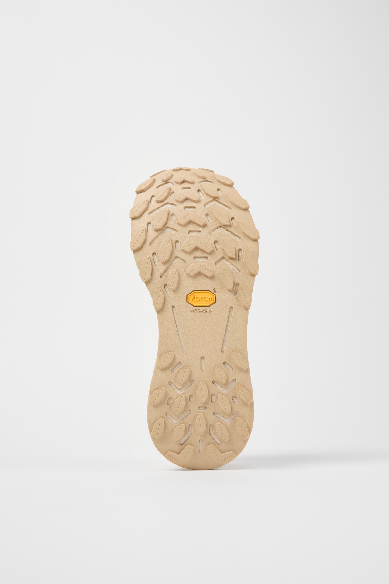 sola de sapato bege com padrão texturizado e logo Vibram no centro