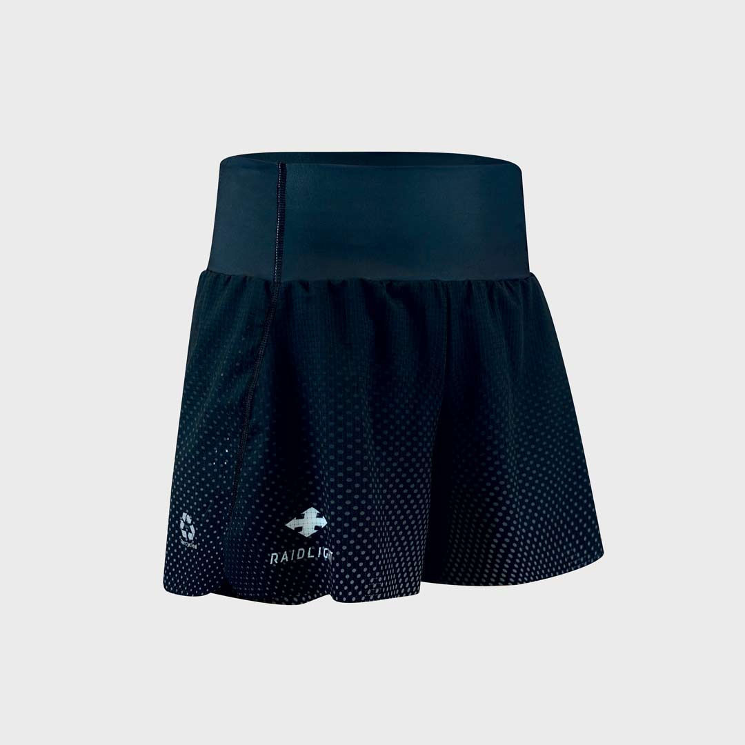 Saia desportiva preta com padrão de pontos e cintura larga.