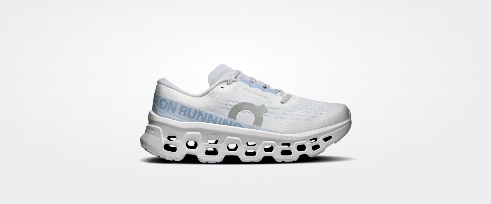 Ténis de corrida branco e cinzento com sola recortada e logo ON RUNNING.