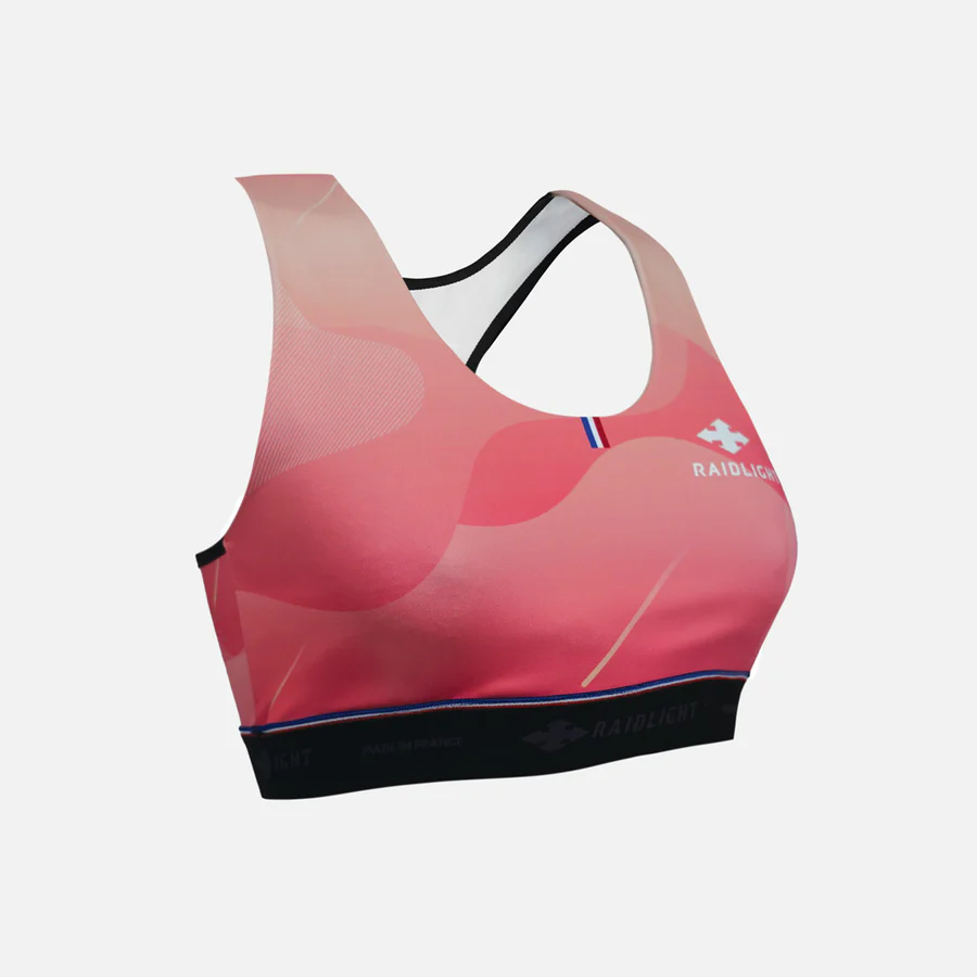 Top desportivo rosa RAIDLIGHT com alças finas cruzadas pretas e logótipo branco