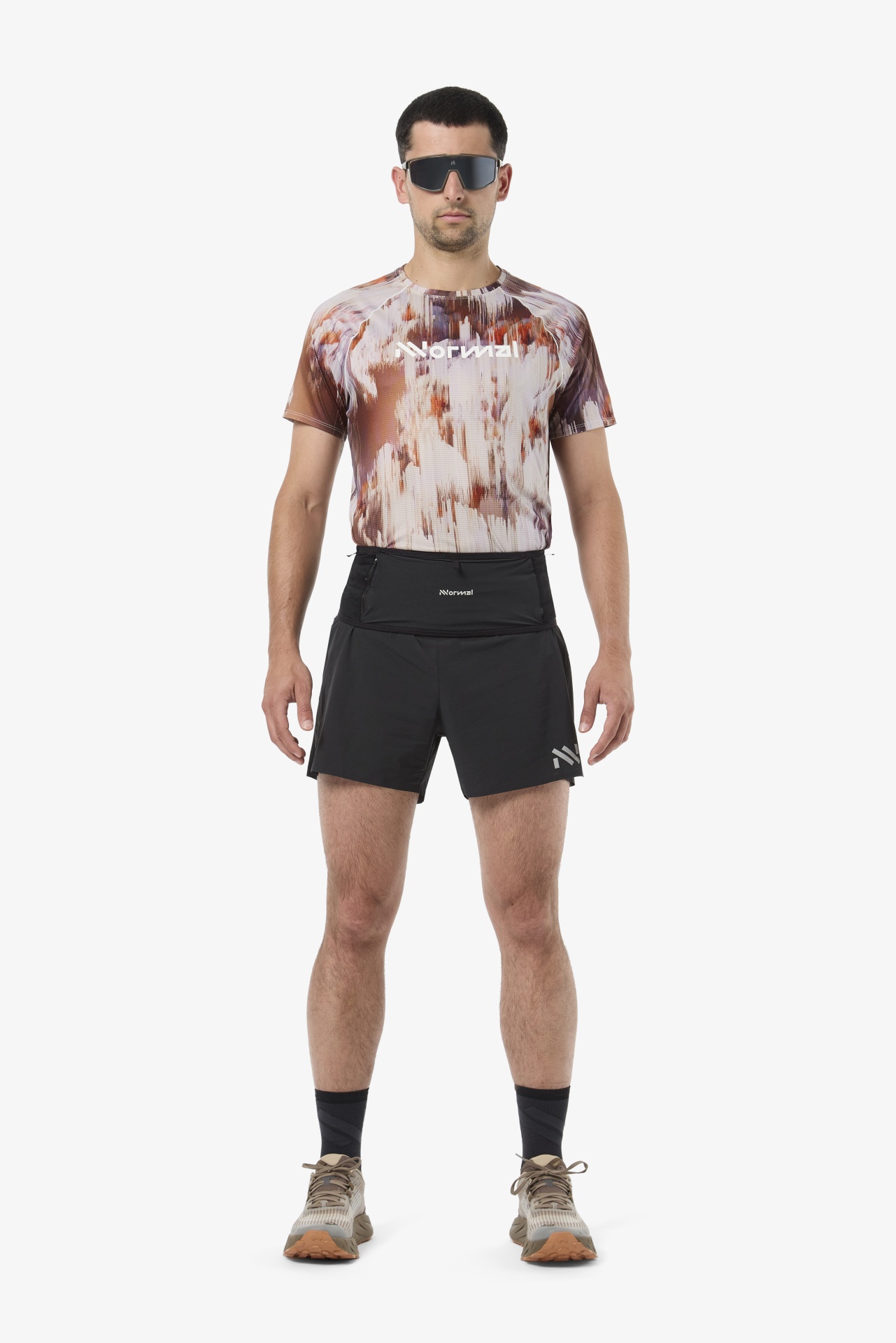Homem com roupa desportiva, óculos escuros e sapatilhas de corrida