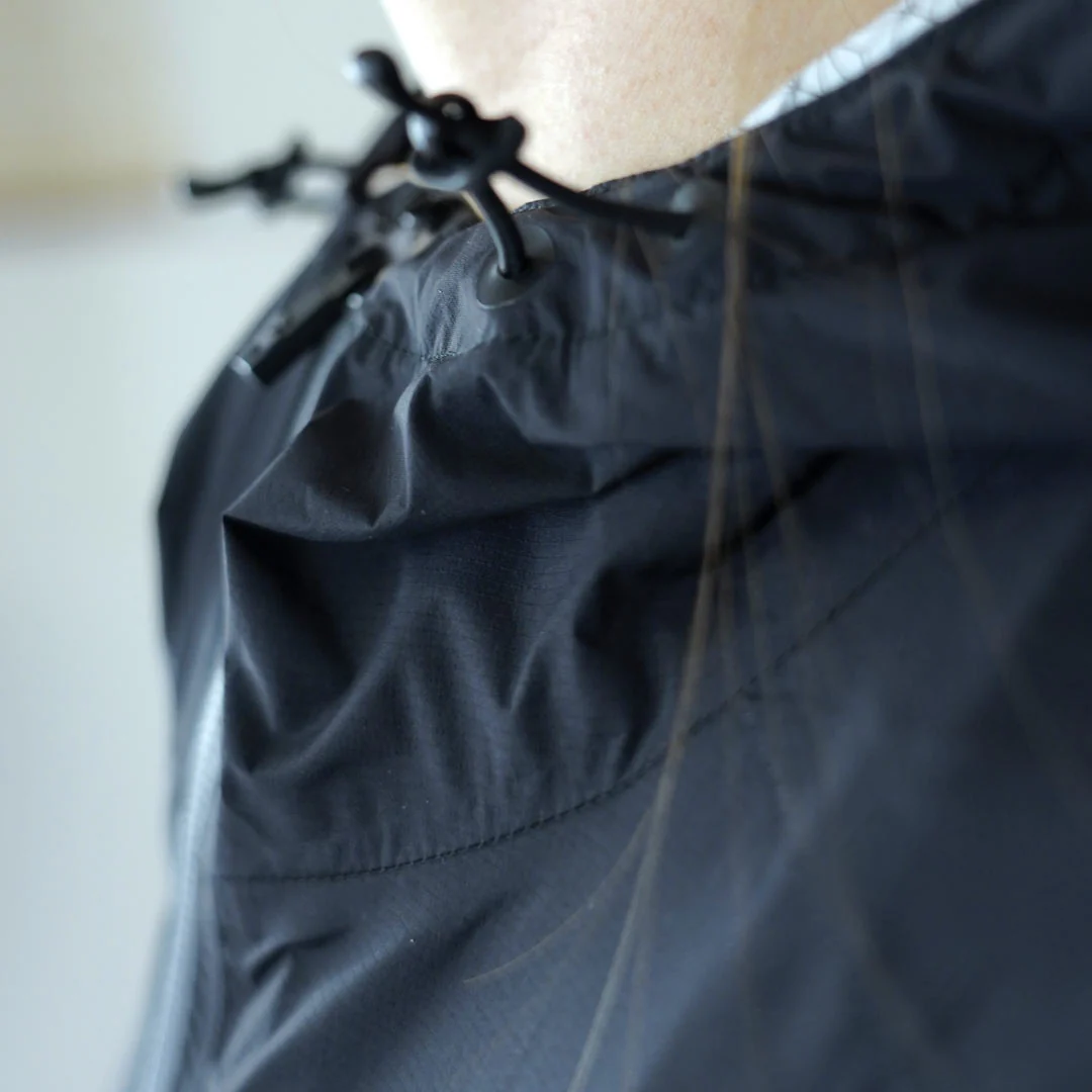 Casaco preto com capuz ajustável e cordão preto