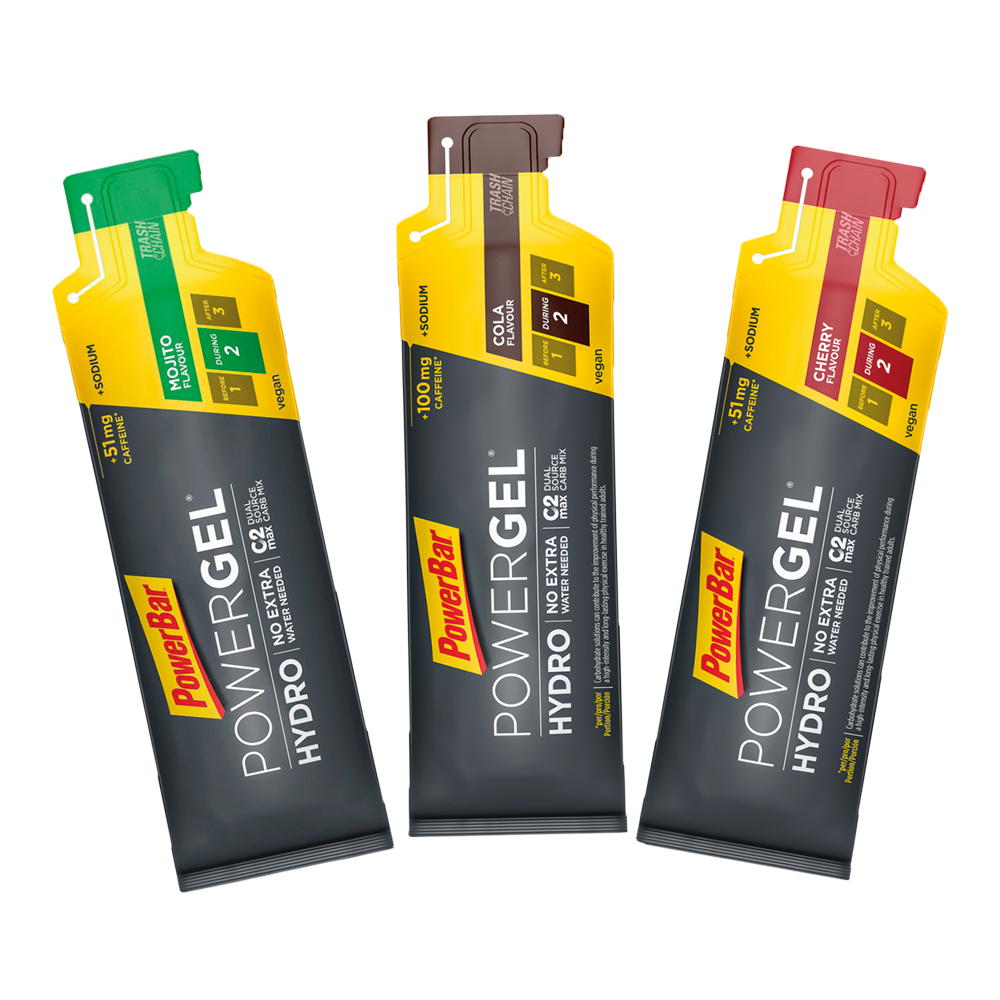 Três sachês PowerBar Powergel Hydro em cores verde, castanho e vermelho com texto motivacional.