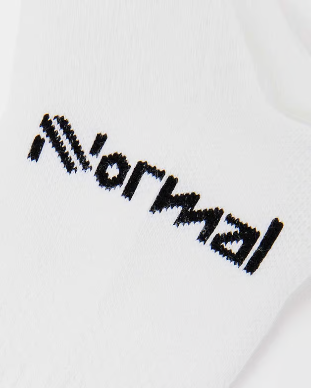 Meia branca com a palavra 'Normal' bordada