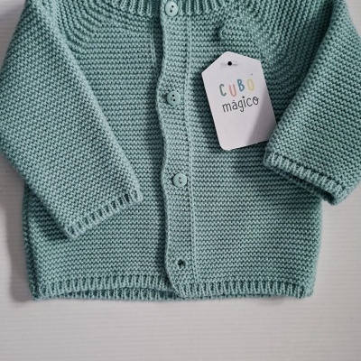 Camisola de bebé azul clara em malha com botões e etiqueta branca