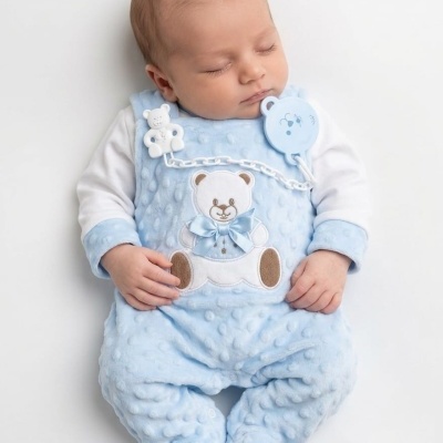 Bebé a dormir com fato azul e prendedeira de chupeta azul