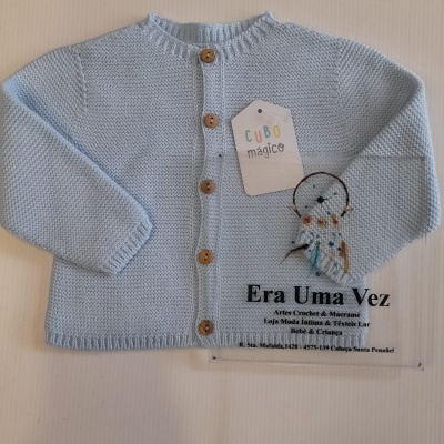 Casaco de malha azul claro com botões de madeira e etiquetas ao lado