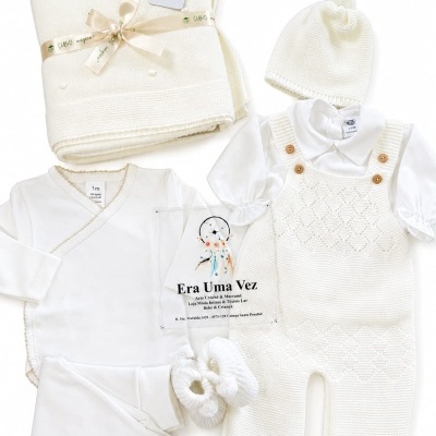 Conjunto de roupa de bebé creme e branca com manta, body, sapatinhos, touca, jardineira e camisa